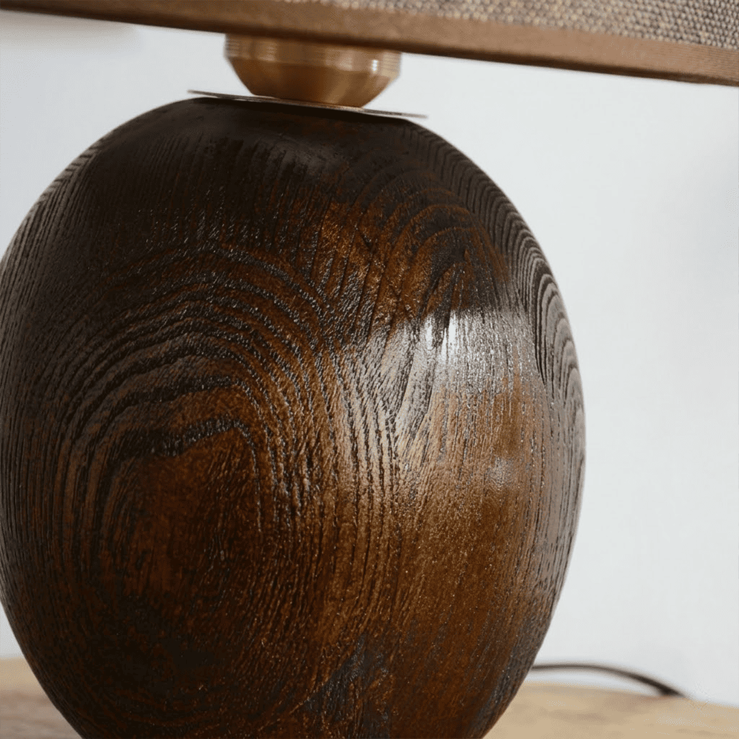 Penna wood table lamp switched on warm light glow bedside nightstand