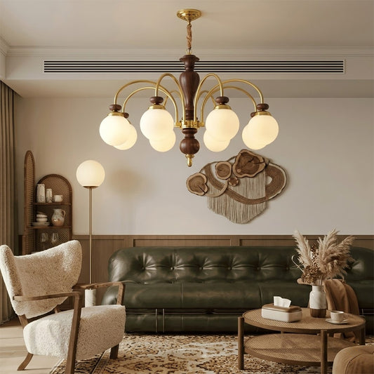 Windsor walnut chandelier above dining table warm glowing light living room