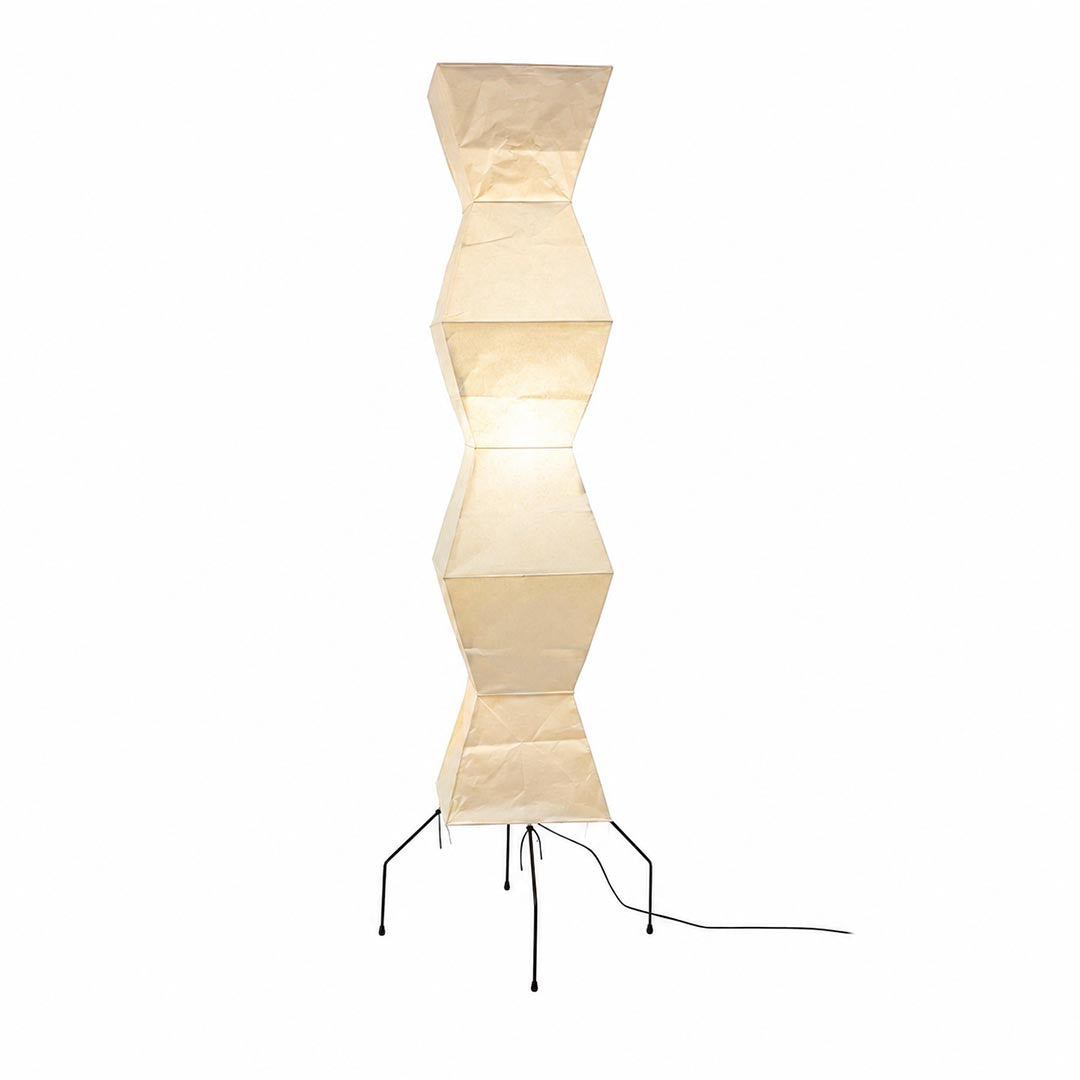 Warmly glowing paper shade of the Akari UF4-L9 Geometric Floor Lamp against a white background by Stuber Lighting.