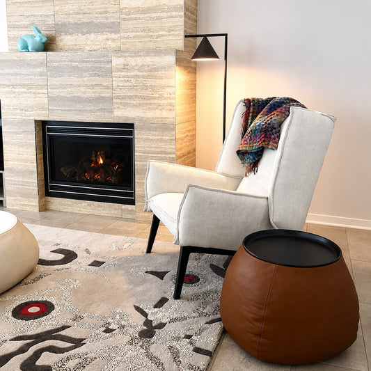 Girevole marble floor lamp angled over an armchair to direct warm reading light in a corner