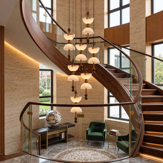 7-light Clessidra alabaster spiral chandelier filling a two-story foyer with soft warm light