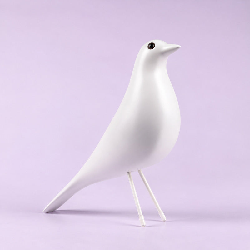 White Eames House Bird sculpture as a soft minimalist accent on a light-toned shelf