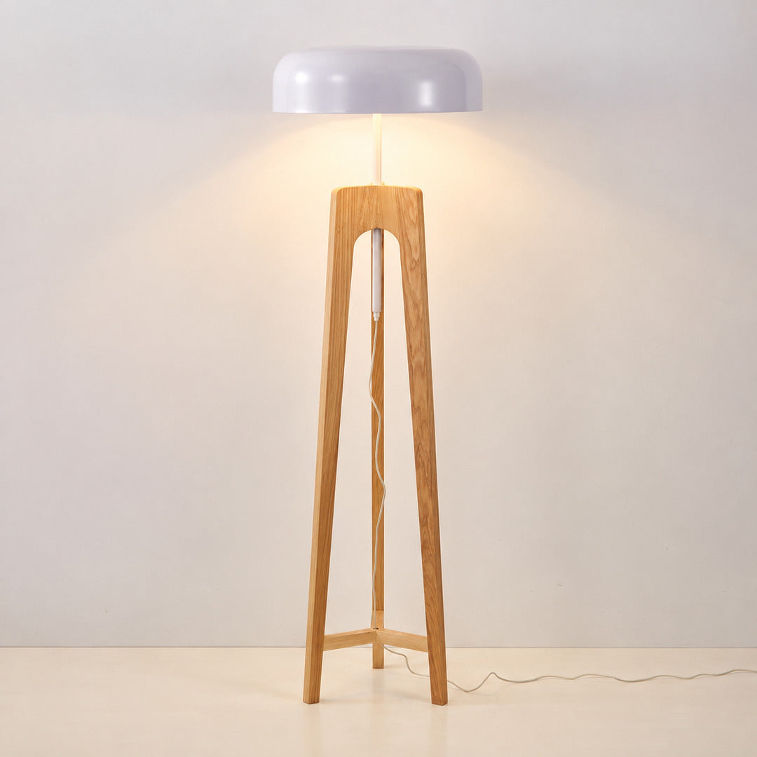 Natural wood and white Fungo floor lamp adding a light Scandinavian accent beside an armchair