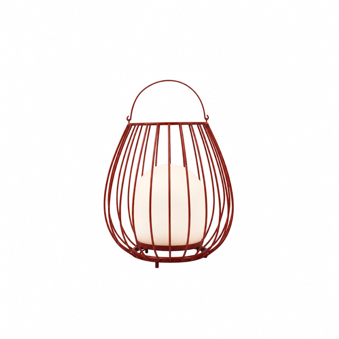 Red Gabbia rechargeable lantern adding a pop of color to a poolside patio at night