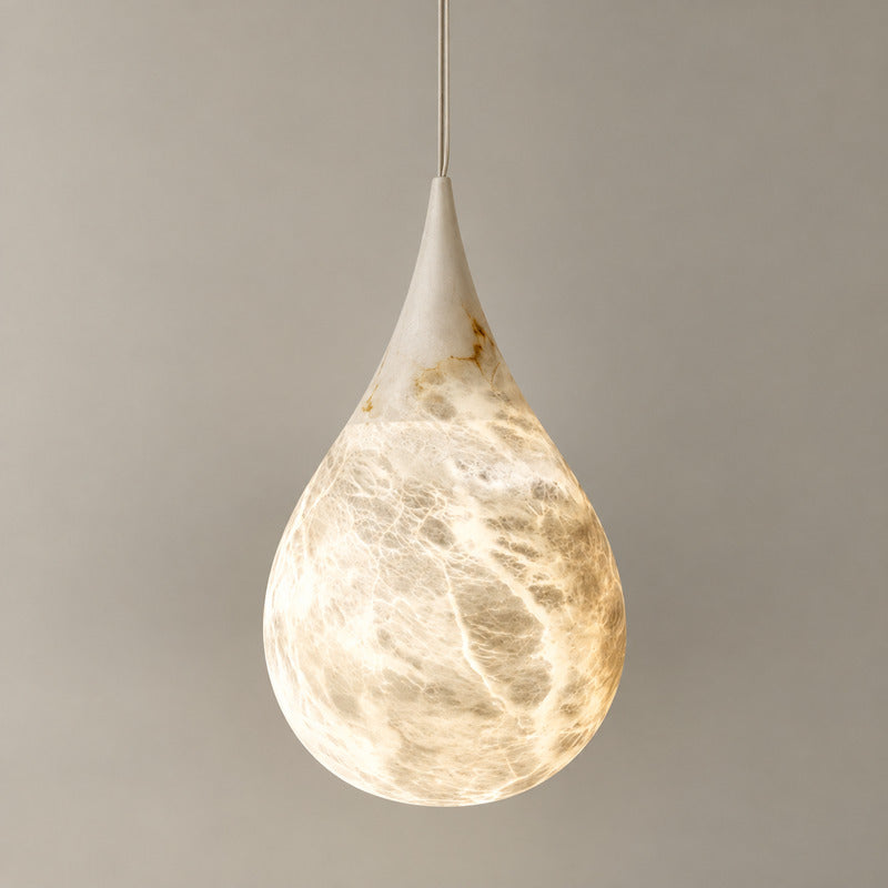 Larger 7.1-inch Goccia alabaster raindrop pendant centered over a kitchen counter