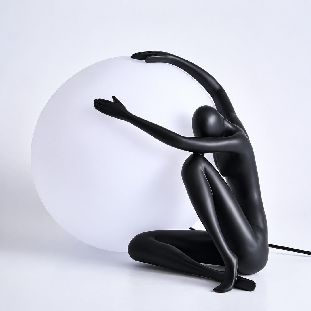 Large black Musa sculpture table lamp as a statement piece on a living room console