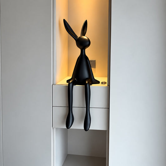 Rabbit resin sculpture on a media console adding a playful modern touch
