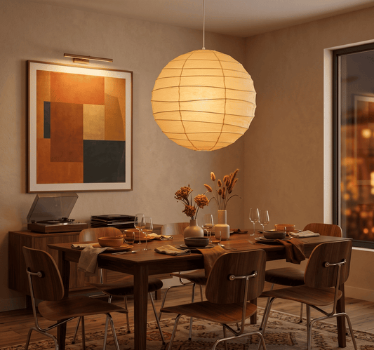 "Stuber handcrafted washi paper sphere pendant light emitting a warm, diffuse glow for minimalist Japandi interiors."