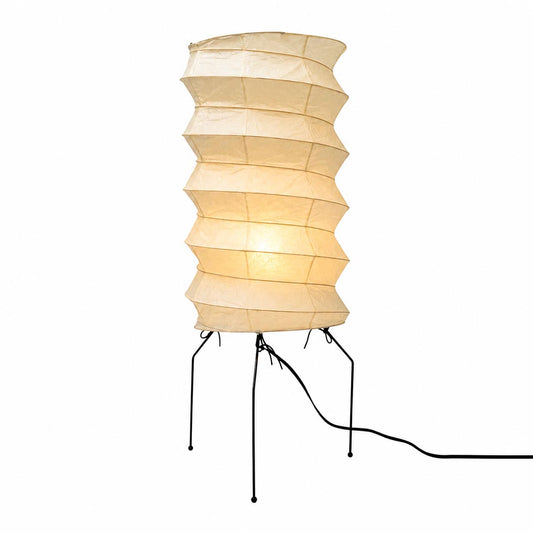 Studio portrait of the illuminated ribbed cylinder Washi Paper UF2-31N Table Lamp with metal wire legs against white backdrop by Stuber Lighting.