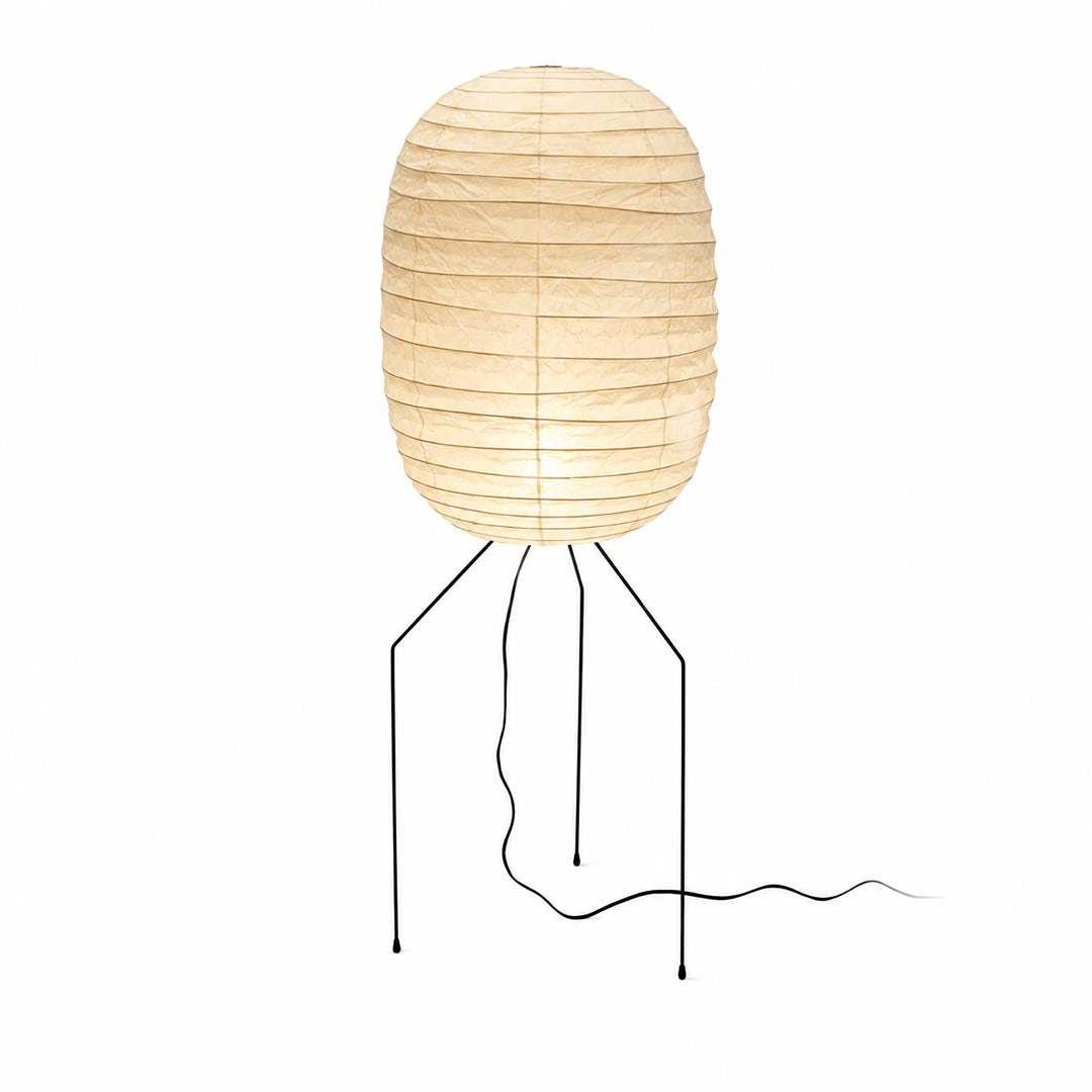 Studio portrait of the illuminated capsule Washi Paper UF3-DL Floor Lamp with black metal legs against white backdrop by Stuber Lighting.