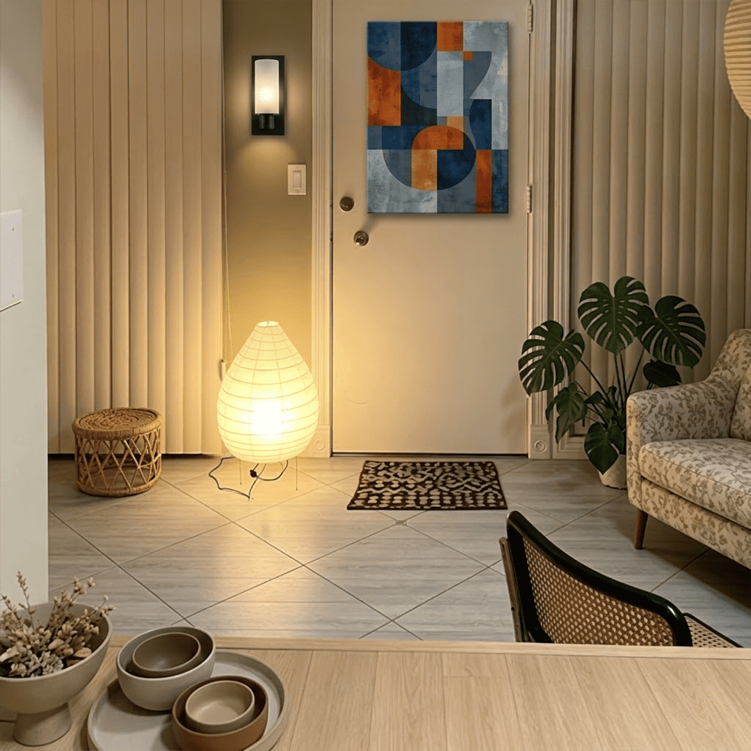 Large 22N Washi paper table lamp with bamboo ribs, glowing warmly on a minimalist floor setting.