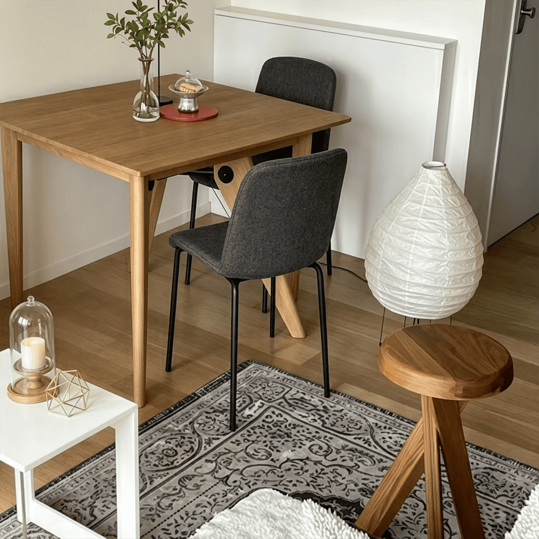 Large 22N Washi paper table lamp with bamboo ribs, glowing warmly on a minimalist floor setting.