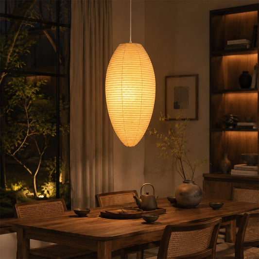 23A 24A washi paper oval pendant light emitting a soft warm glow above a dark wooden dining table