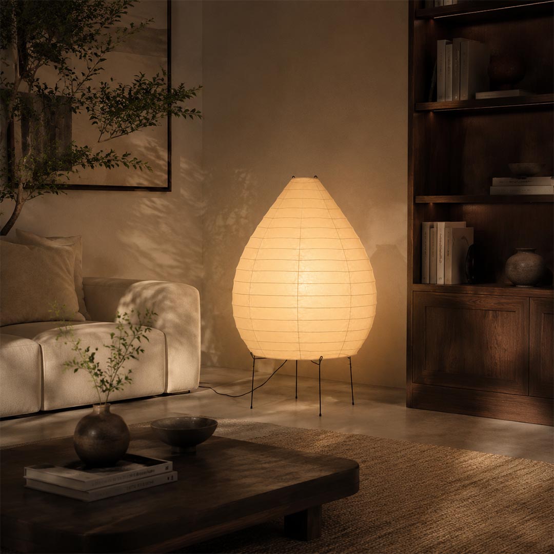 Cozy living room setup featuring an illuminated 23N washi paper pear shape sculptural floor lamp next to a sofa