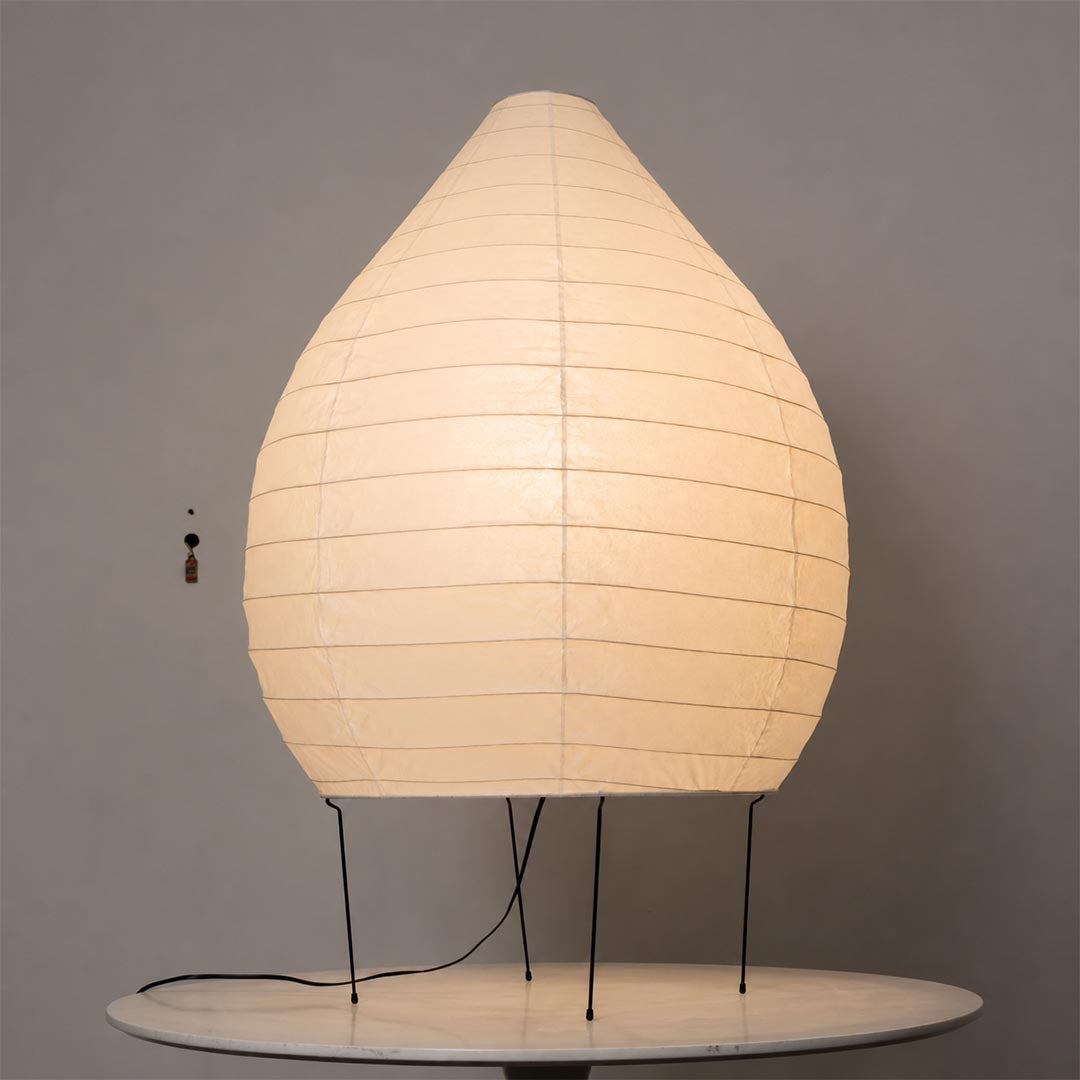 23N washi paper pear shape sculptural floor lamp glowing warmly against a minimalist clean backdrop