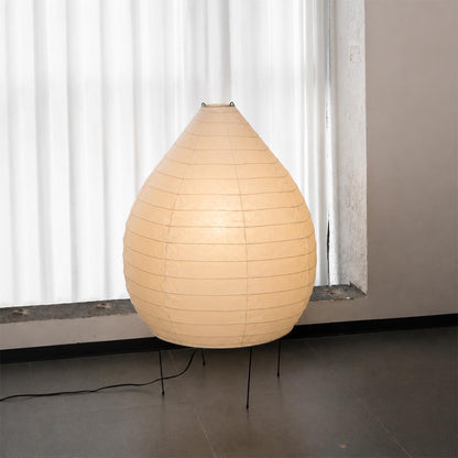 Japanese style 23N washi paper pear shape floor lamp placed in front of a bright window with blinds