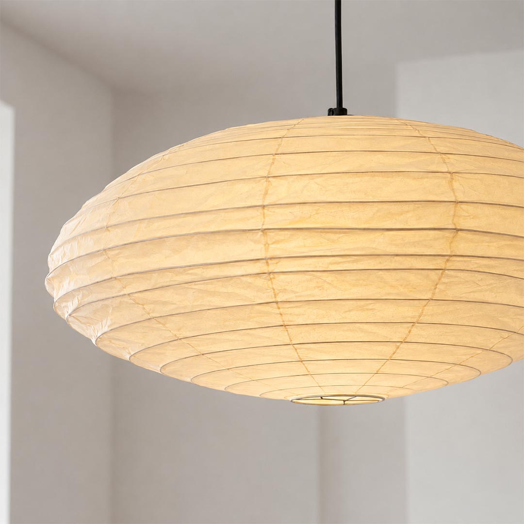 Close-up shot of Stuber Lighting Japanese paper pendant lamp showing the premium handmade rice paper texture and fine ribbed metal framework details.