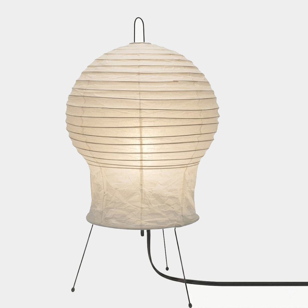 Akari 2N Table Lamp handmade with mulberry paper on a minimalist tripod stand, warm light glowing through textured washi paper.