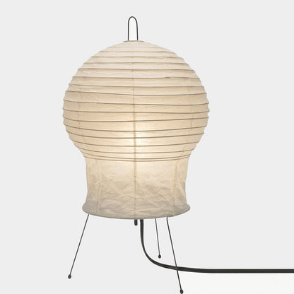 Akari 2N Table Lamp handmade with mulberry paper on a minimalist tripod stand, warm light glowing through textured washi paper.