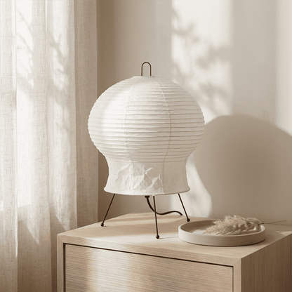 Akari 2N Table Lamp handmade with mulberry paper on a minimalist tripod stand, warm light glowing through textured washi paper.