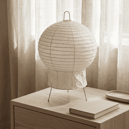 Akari 2N Table Lamp handmade with mulberry paper on a minimalist tripod stand, warm light glowing through textured washi paper.