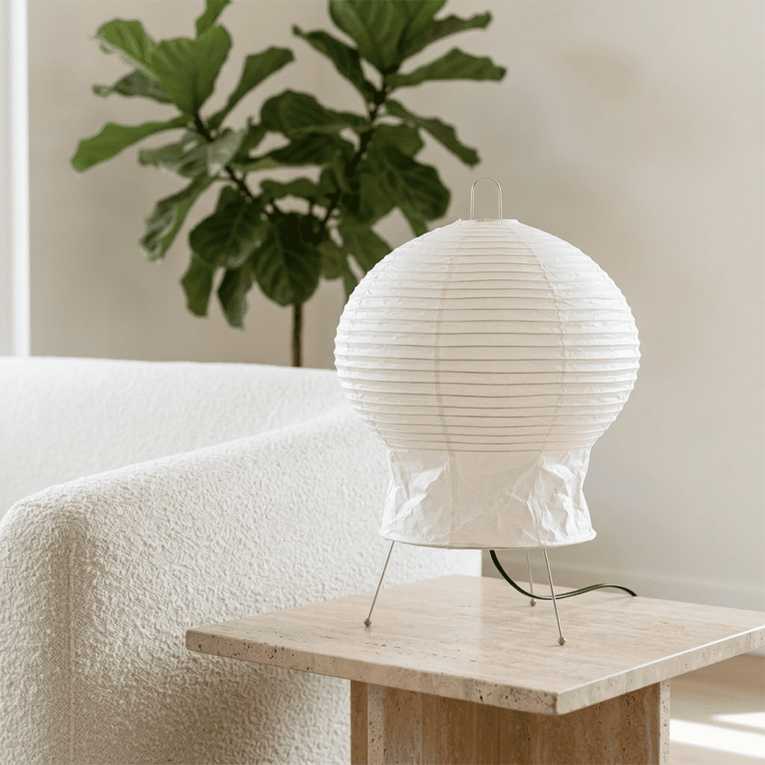 Akari 2N Table Lamp handmade with mulberry paper on a minimalist tripod stand, warm light glowing through textured washi paper.