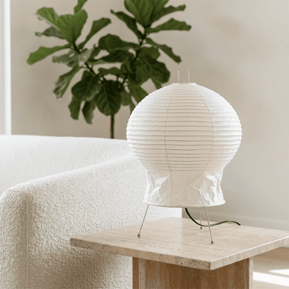 Akari 2N Table Lamp handmade with mulberry paper on a minimalist tripod stand, warm light glowing through textured washi paper.