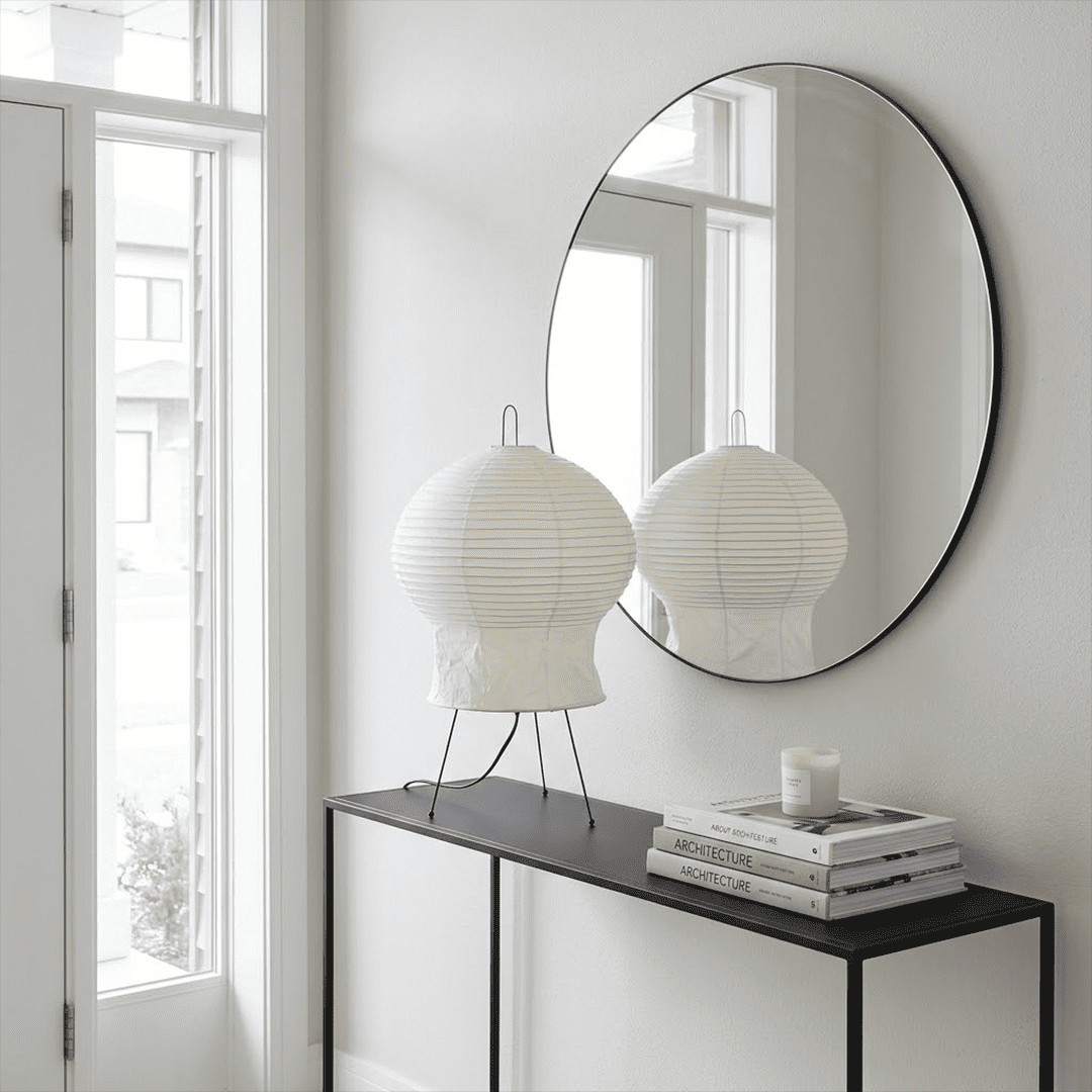 Akari 2N Table Lamp handmade with mulberry paper on a minimalist tripod stand, warm light glowing through textured washi paper.