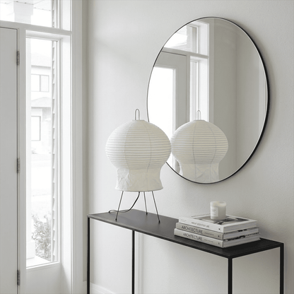 Akari 2N Table Lamp handmade with mulberry paper on a minimalist tripod stand, warm light glowing through textured washi paper.