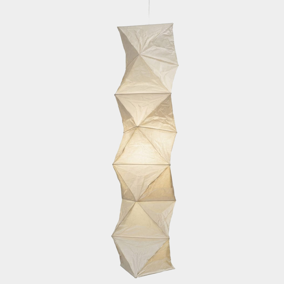 Large Akari L8 style vertical washi paper pendant light, 63 inches tall with accordion folds, emitting a warm ethereal glow.
