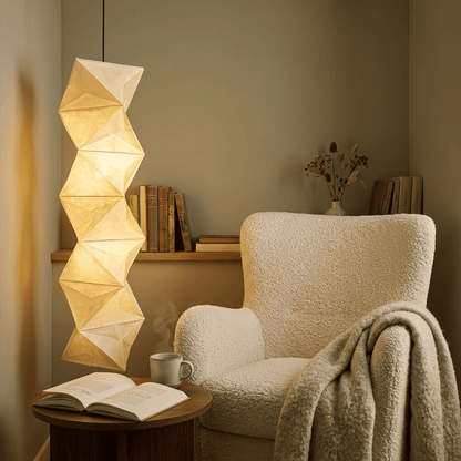 Large Akari L8 style vertical washi paper pendant light, 63 inches tall with accordion folds, emitting a warm ethereal glow.