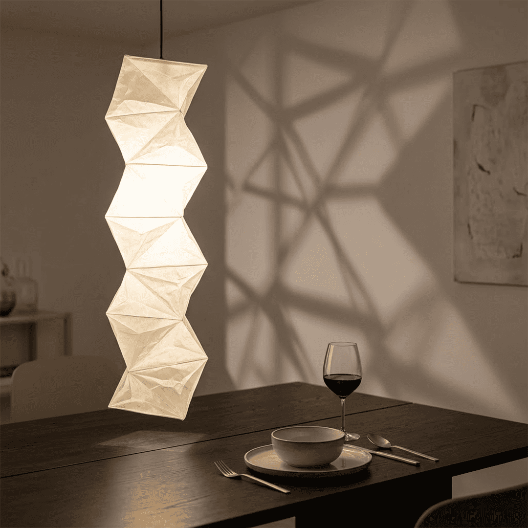 Large Akari L8 style vertical washi paper pendant light, 63 inches tall with accordion folds, emitting a warm ethereal glow.