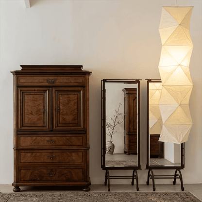 Large Akari L8 style vertical washi paper pendant light, 63 inches tall with accordion folds, emitting a warm ethereal glow.
