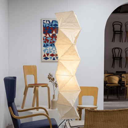 Large Akari L8 style vertical washi paper pendant light, 63 inches tall with accordion folds, emitting a warm ethereal glow.