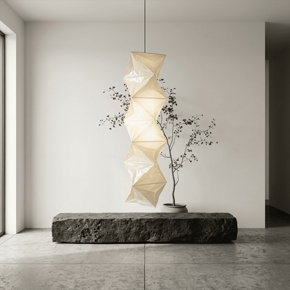Large Akari L8 style vertical washi paper pendant light, 63 inches tall with accordion folds, emitting a warm ethereal glow.