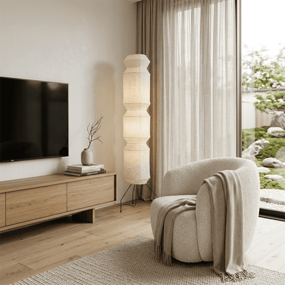 Minimalist modern home lamp: A sculptural Japanese-style multi-tiered paper floor lamp with a columnar design, providing warm interior decoration lighting for a cozy atmosphere.