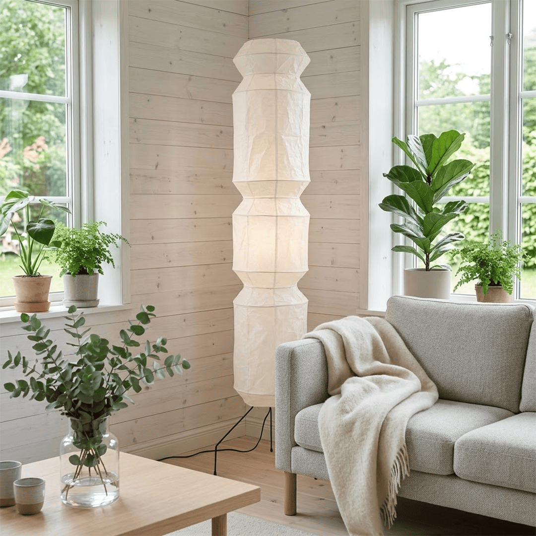 Minimalist modern home lamp: A sculptural Japanese-style multi-tiered paper floor lamp with a columnar design, providing warm interior decoration lighting for a cozy atmosphere.