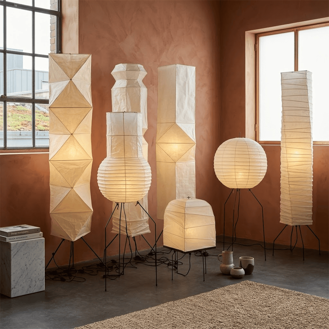 Minimalist modern home lamp: A sculptural Japanese-style multi-tiered paper floor lamp with a columnar design, providing warm interior decoration lighting for a cozy atmosphere.