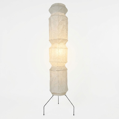 Minimalist modern home lamp: A sculptural Japanese-style multi-tiered paper floor lamp with a columnar design, providing warm interior decoration lighting for a cozy atmosphere.