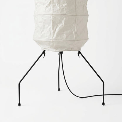 Minimalist modern home lamp: A sculptural Japanese-style multi-tiered paper floor lamp with a columnar design, providing warm interior decoration lighting for a cozy atmosphere.