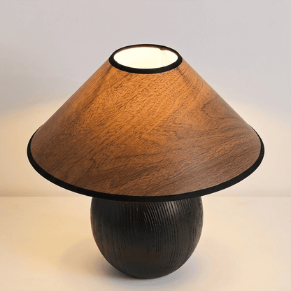 Penna wood table lamp switched on warm light glow bedside nightstand