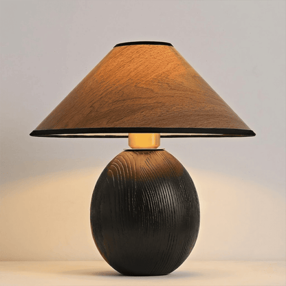 Penna wood table lamp switched on warm light glow bedside nightstand