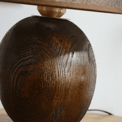 Penna wood table lamp switched on warm light glow bedside nightstand