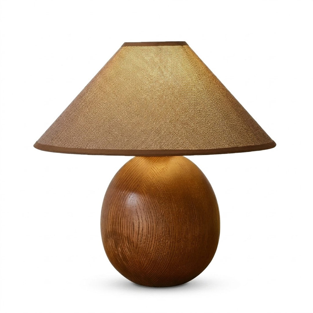 Penna wood table lamp switched on warm light glow bedside nightstand