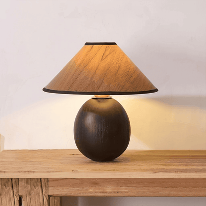 Penna wood table lamp switched on warm light glow bedside nightstand
