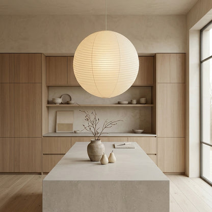 Large Washi paper sphere pendant light hanging in a minimalist Japandi style bedroom with warm light.