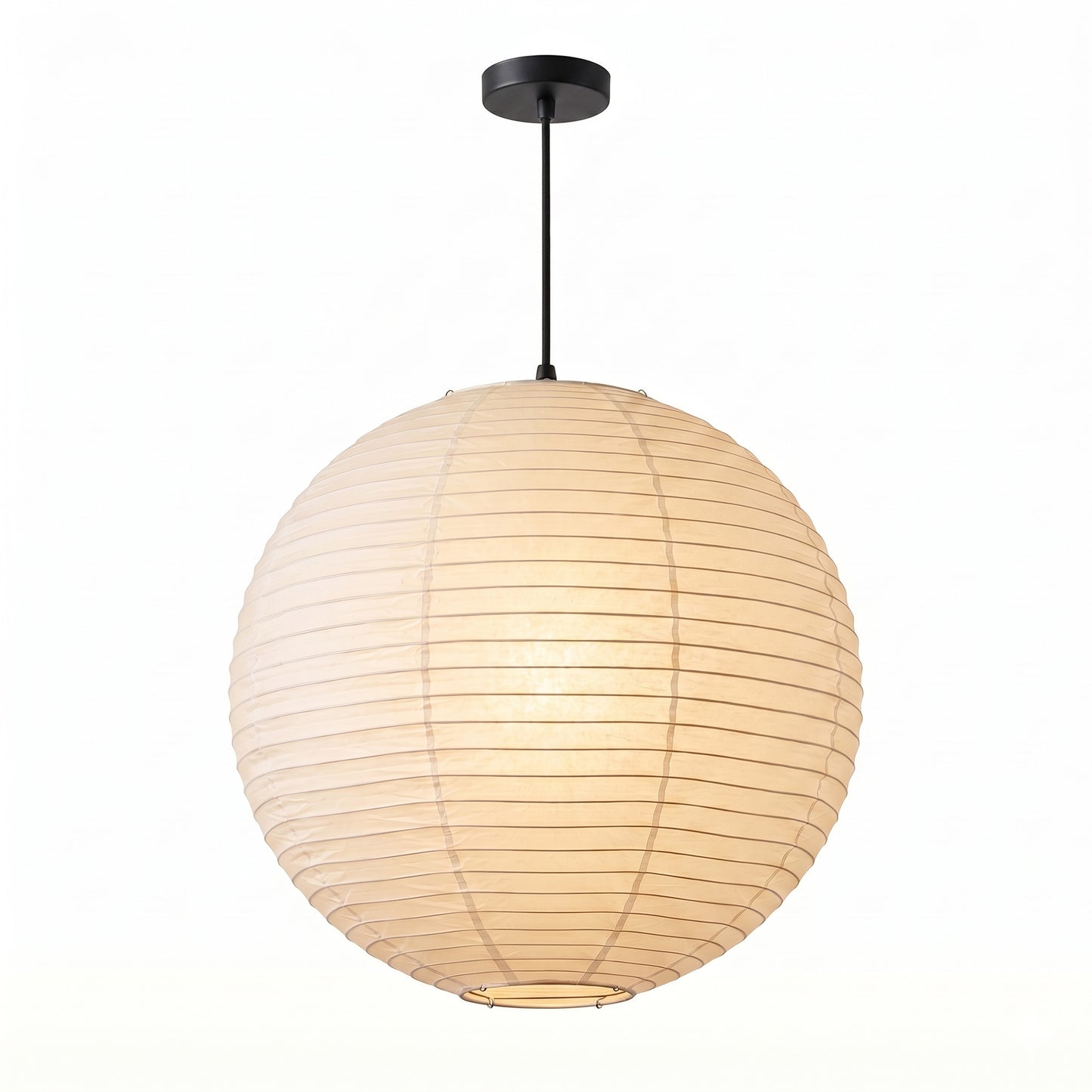 Large Washi paper sphere pendant light hanging in a minimalist Japandi style bedroom with warm light.