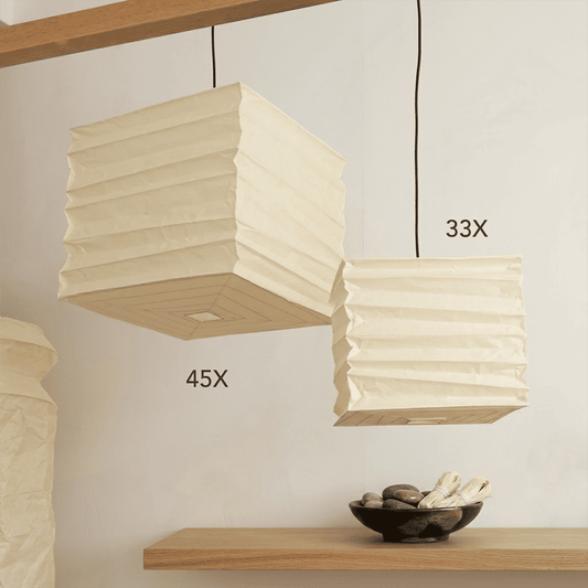 A handcrafted, square Washi paper pendant lamp (Model 33X)—suspended within a room—exudes an innate artistic flair, showcasing the distinctive texture and grain of mulberry bark paper.