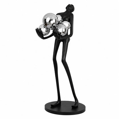 Abbraccio glass floor lamp with a sculptural cluster of glowing glass globes on a black frame in a living room