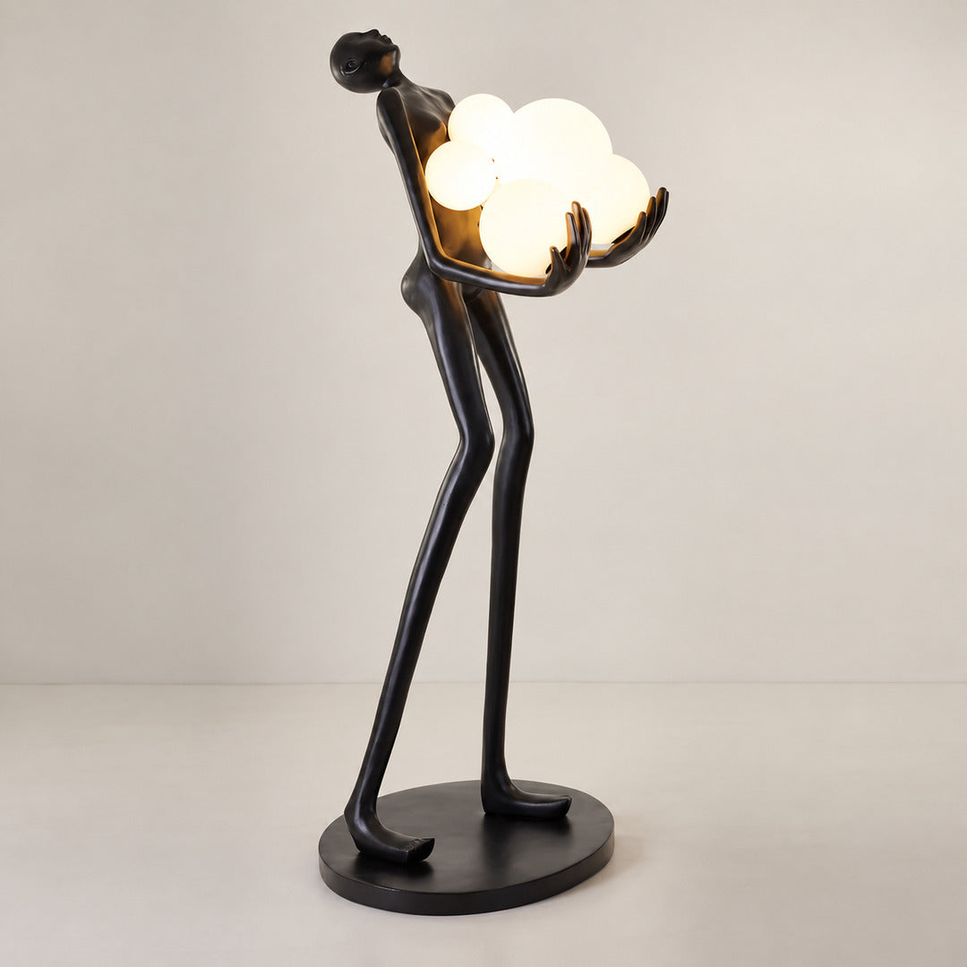 Detail of the glowing glass globes on the Abbraccio floor lamp diffusing warm light